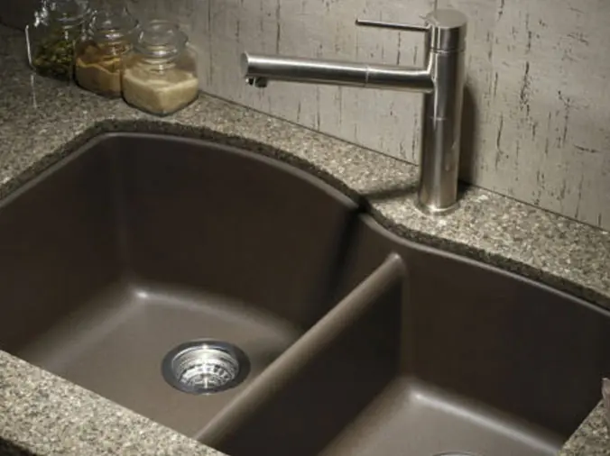 Dark colored kitchen sink with marble counter
