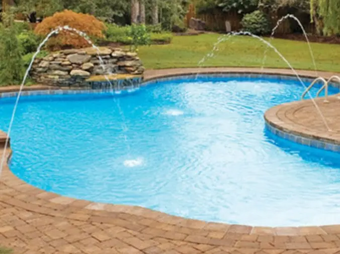 backyard pool with fountains