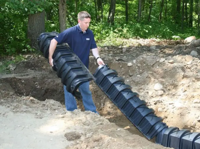 contractor laying out septic equipment