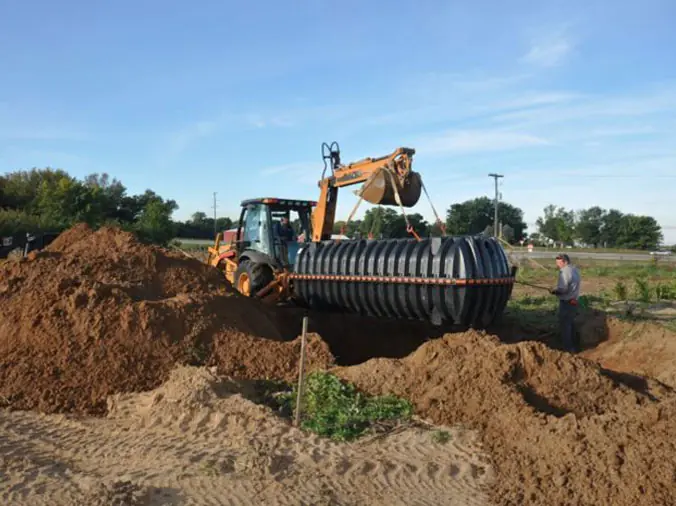 septic tank being installed by tracktor