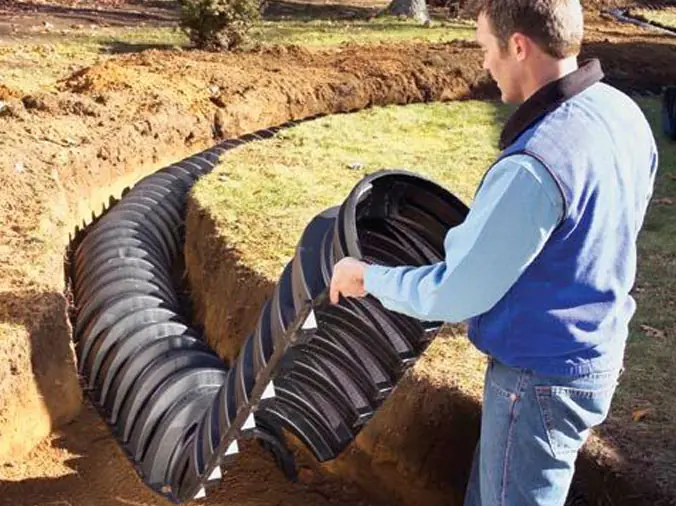 contractor adjusting septic equipment