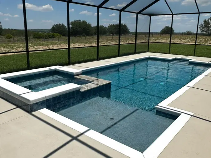 Backyard swimming pool with clear glass enclosure