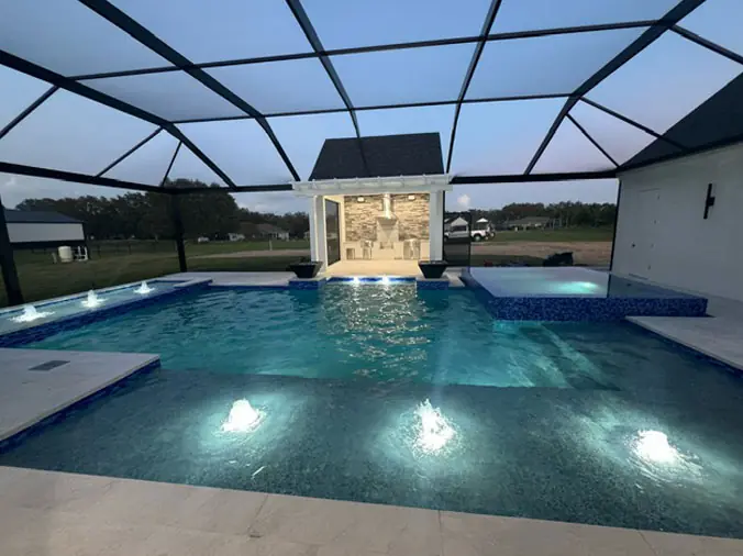 Glass enclosed swimming pool with pool lights