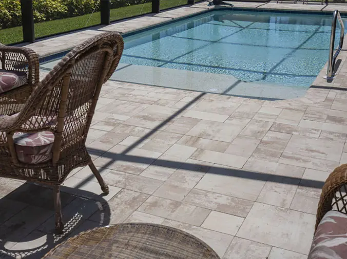 Back yard swimming pool with stone paver deck